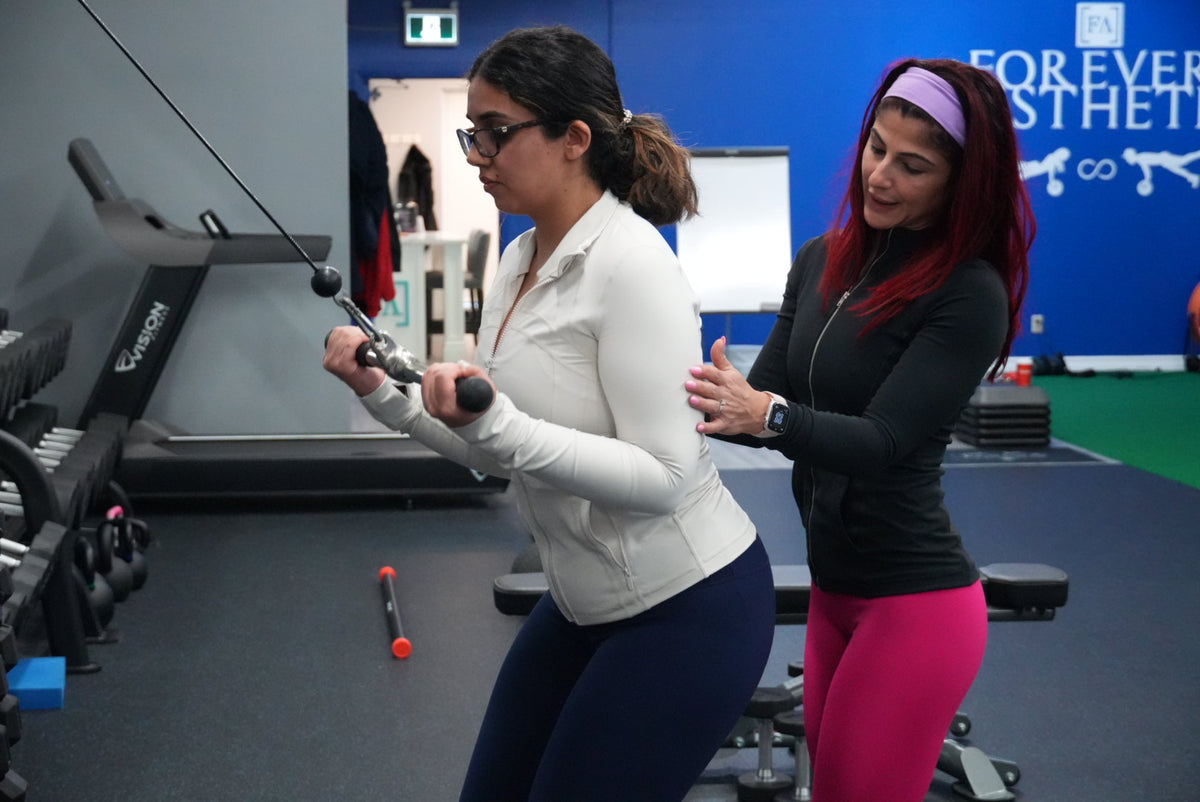 Forever Aesthetic one-on-one personal training with coach guiding a client